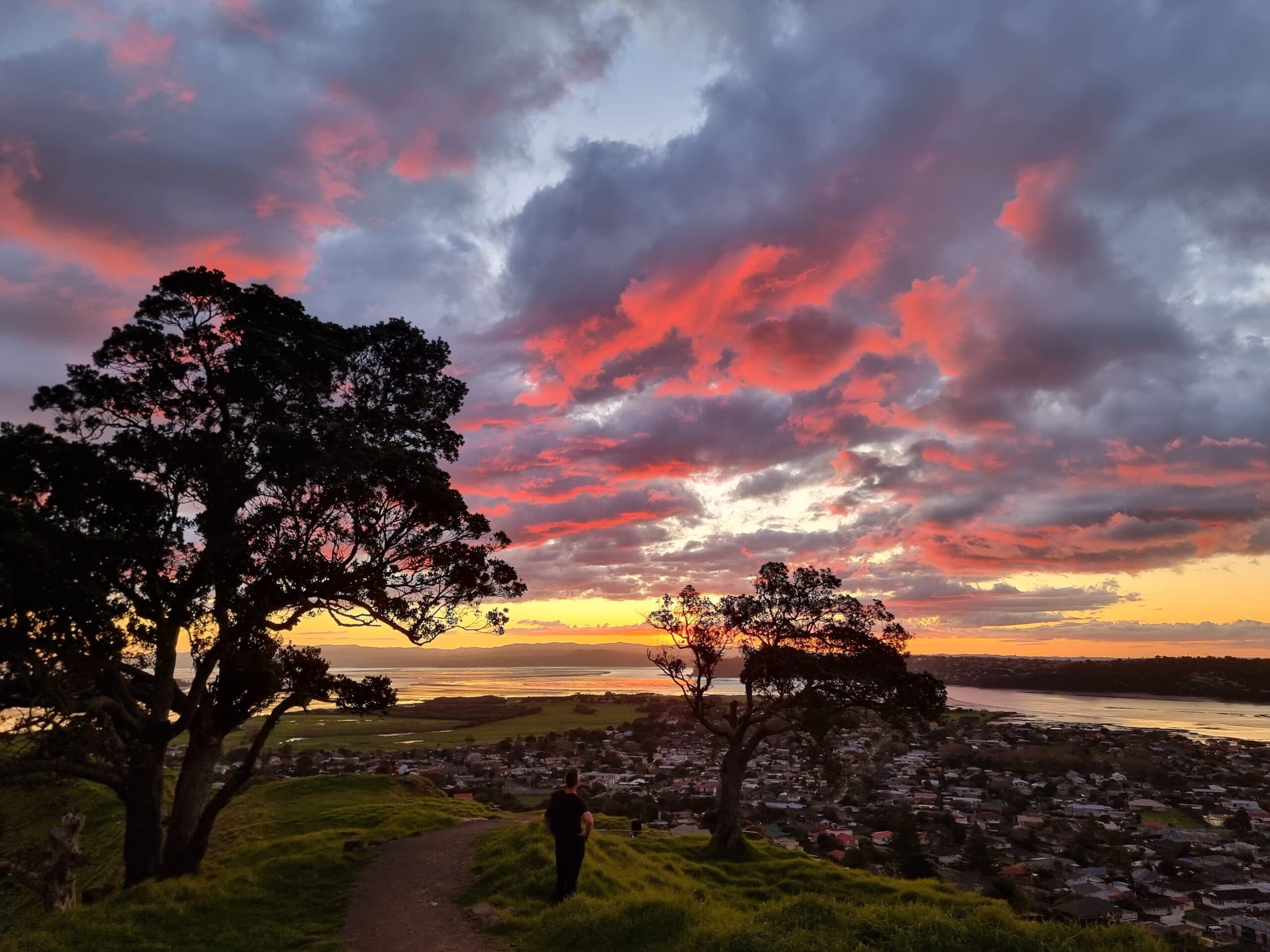Sunsetting over the Manukau Harbour, viewed from on top of Māngere Mountain in Auckland
